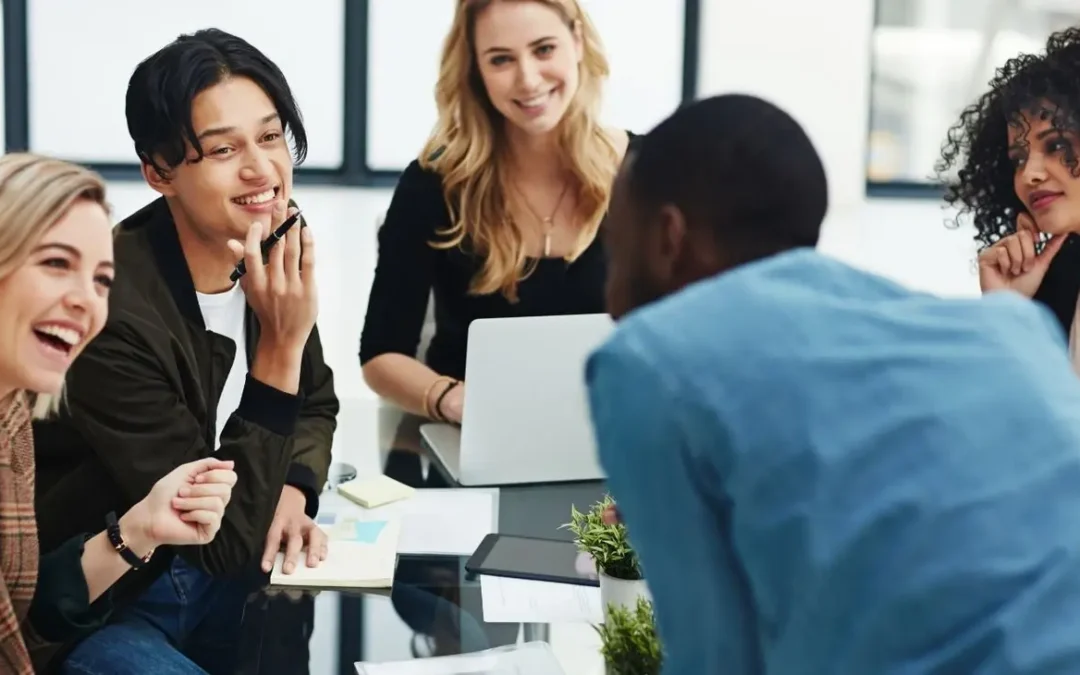 Early-career professionals collaborating around a table in the workplace
