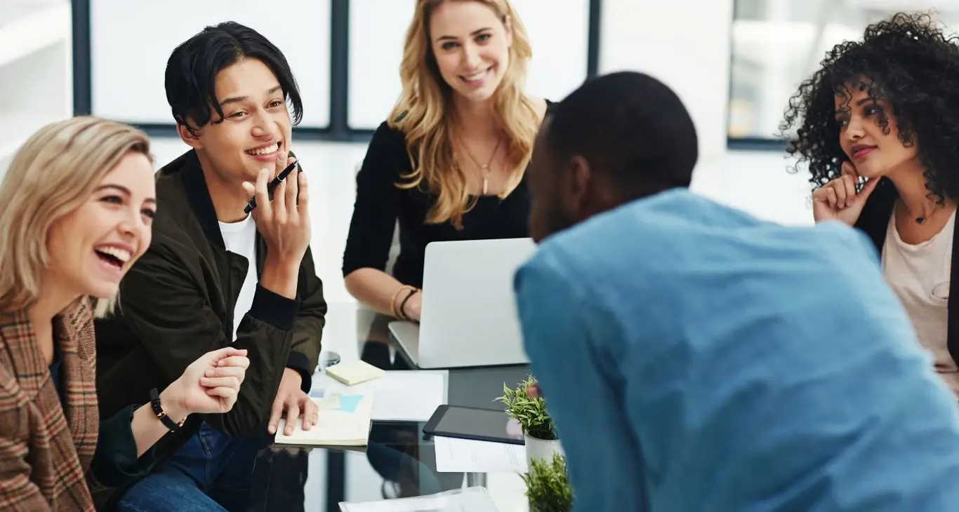 Early-career professionals collaborating around a table in the workplace